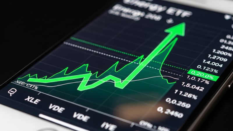 close up of smartphone screen showing energy ETF growing fast with a green arrow, photorealistic 4k
